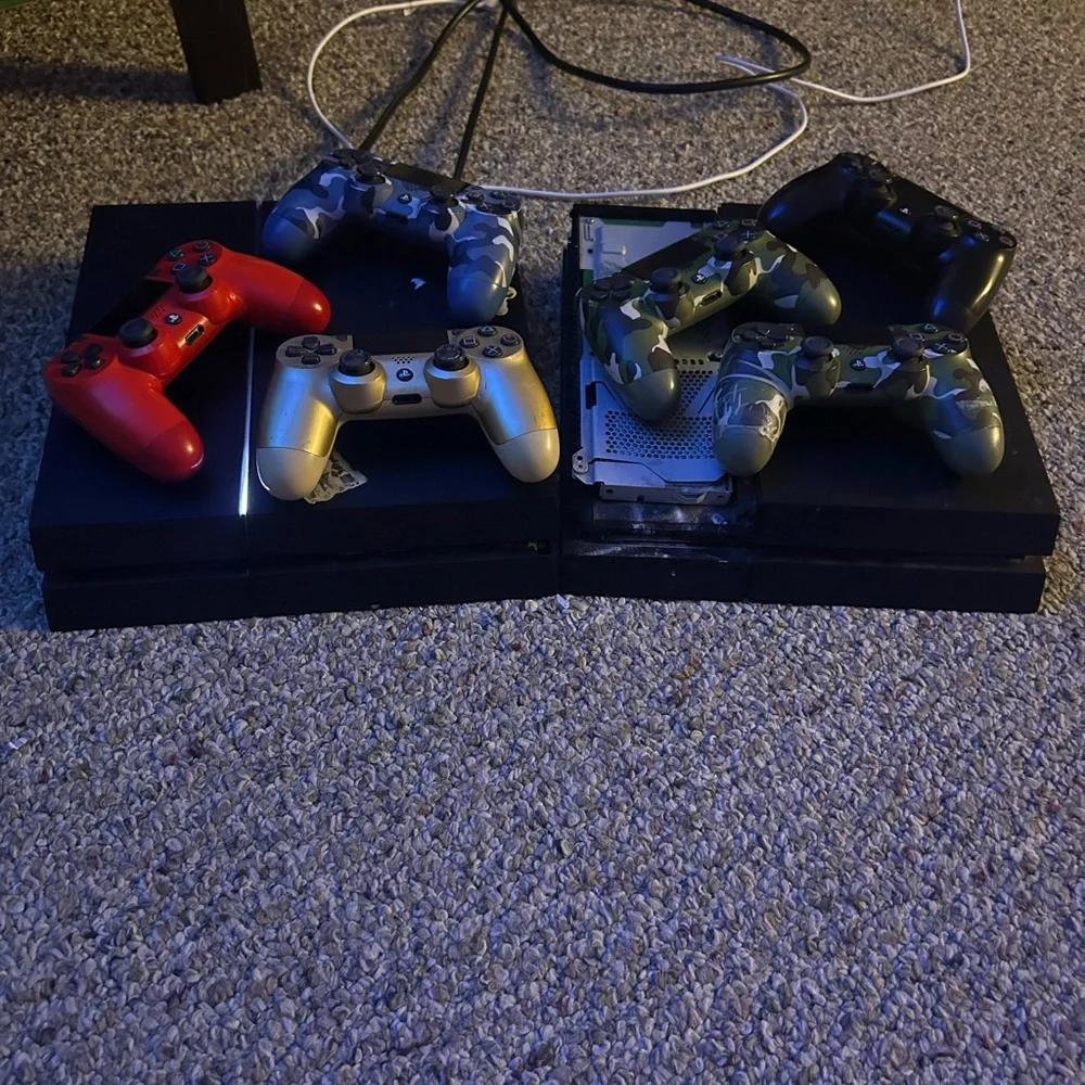 Sony PlayStation Console with Red, Silver, and Camouflage Controllers